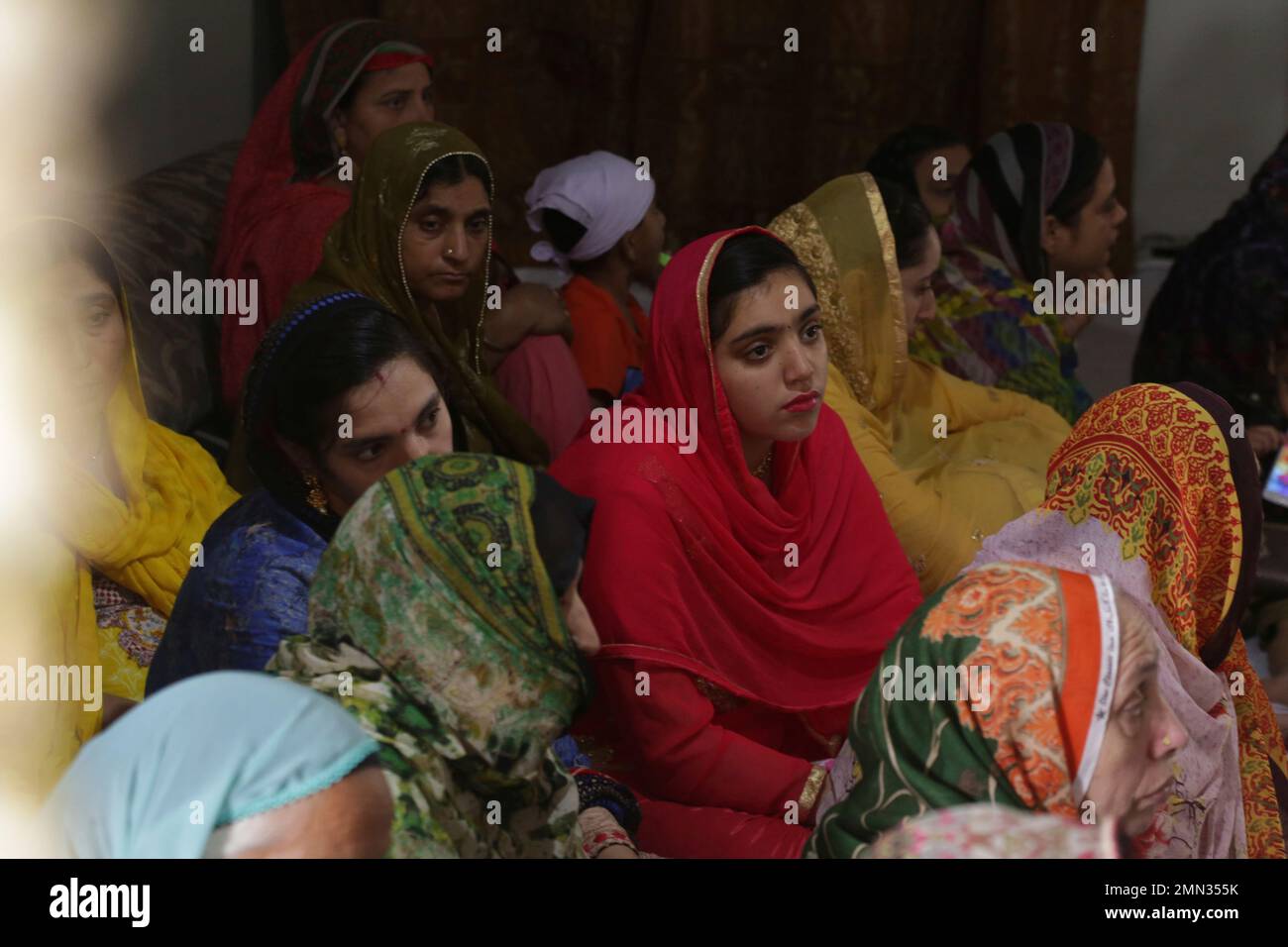 Indian Sikh pilgrims attend a ritual at a temple in Lahore, Pakistan ...