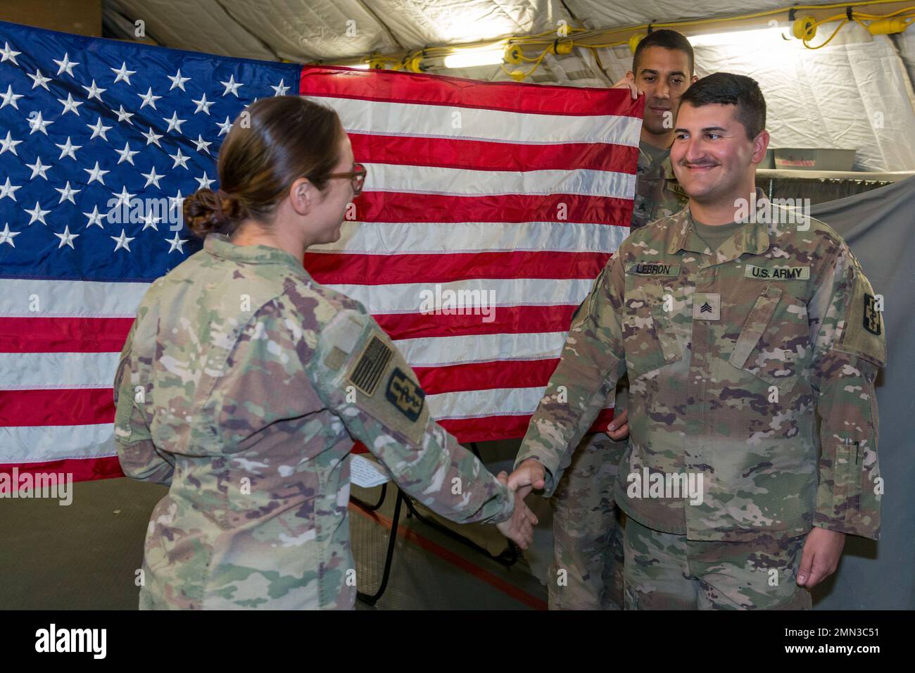 Sgt. Peter Lebron III, who is a combat medic with the 801st Field Hospital, re-enlists for another 8 years while deployed to Iraq. Sgt. Lebron is a movement NCO for Joint Task Force Med 374 and is tasked with booking and tracking flights for medical personnel entering and leaving Central Command’s area of responsibility under Operation Inherent Resolve. Stock Photo