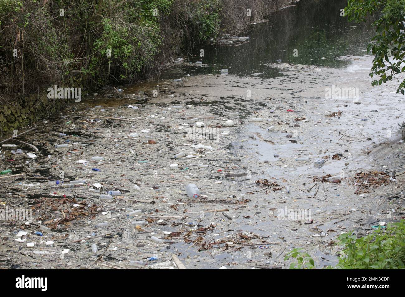 A giant floating rubbish heap floating in the river, plastic pollution