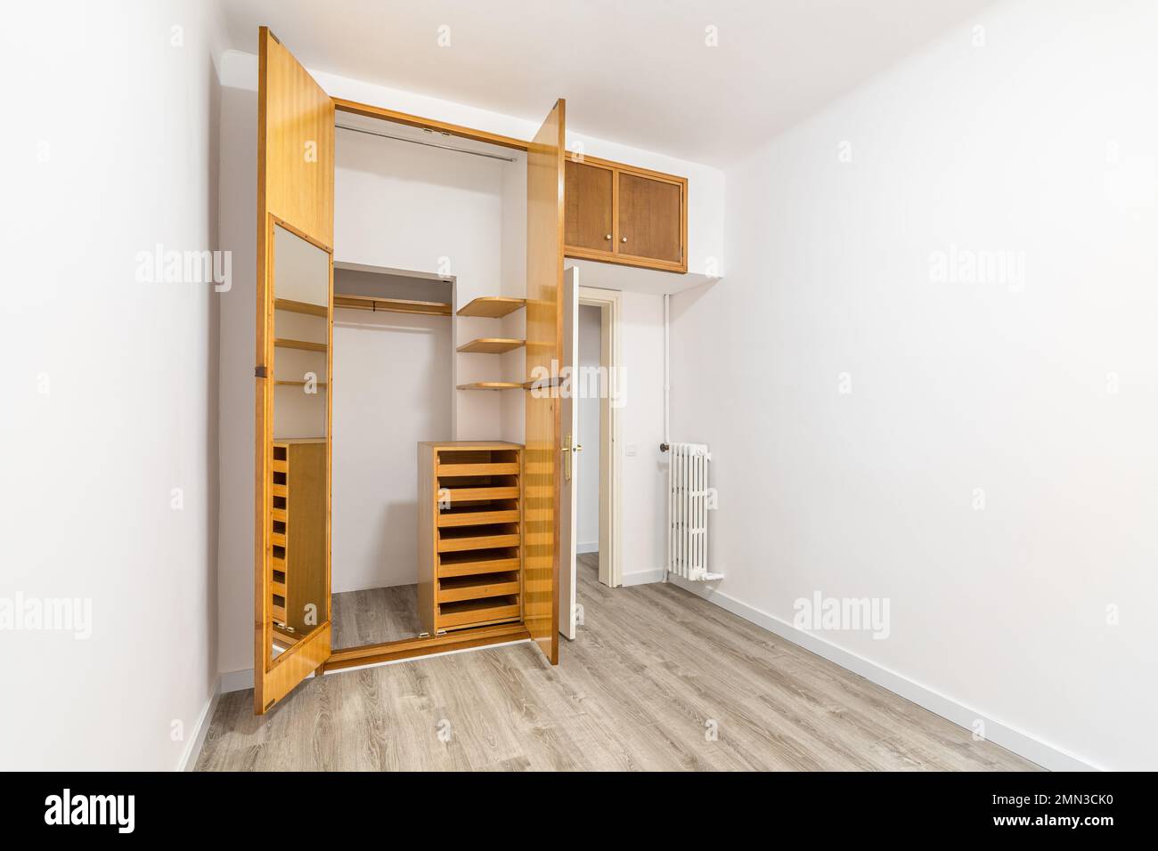 Living room with an outdated design and white walls, in need of repair