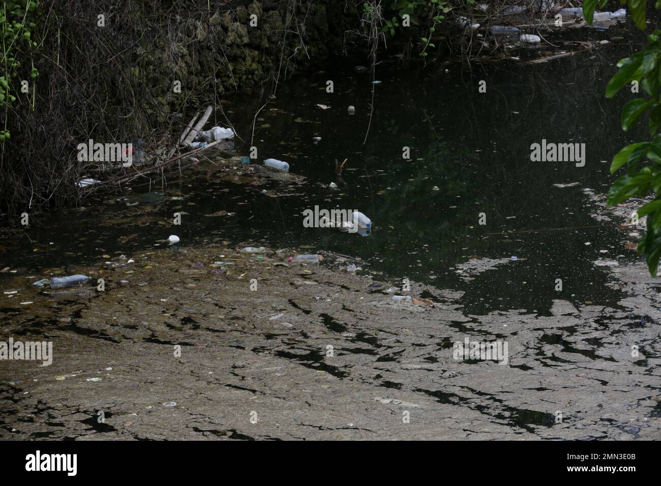 A giant floating rubbish heap floating in the river, plastic pollution ...
