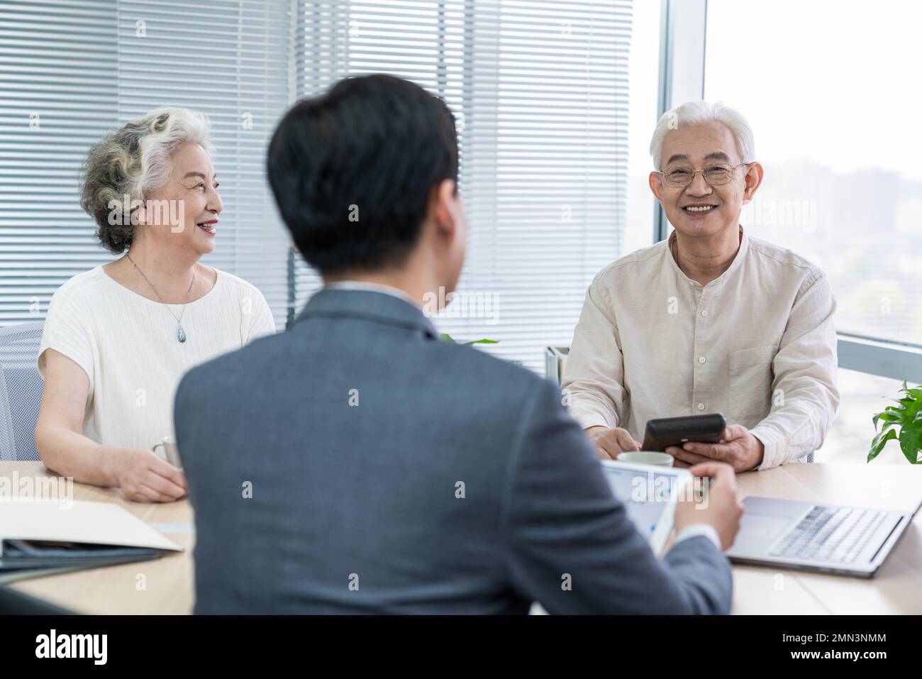 Older couples with a financial adviser Stock Photo