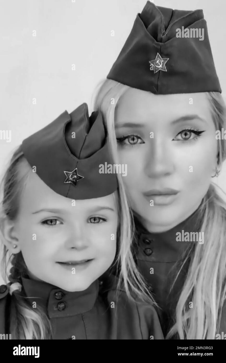 Russian female soldier poses for a portrait with her daughter Stock Photo