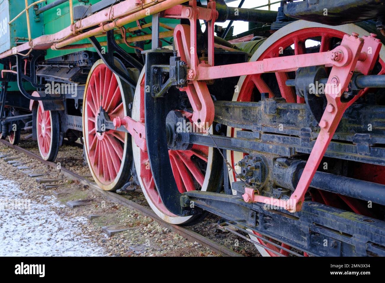 Old steam locomotive wheel and connecting rods. Tie rod or side rod for drive wheels. A retro specimen. Stock Photo