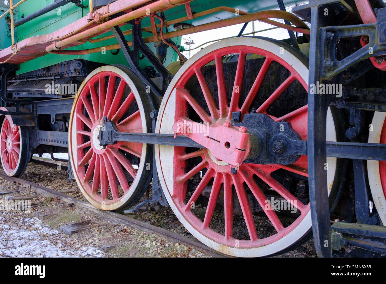 Old steam locomotive wheel and connecting rods. Tie rod or side rod for drive wheels. A retro specimen. Stock Photo