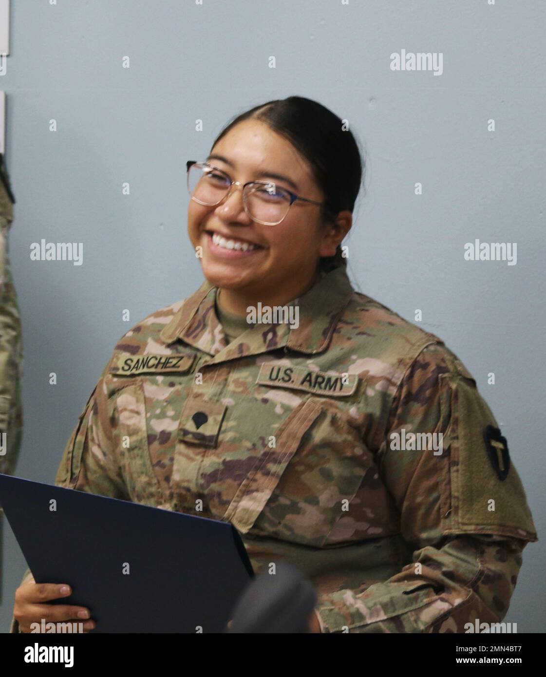 U.S. Army Spc. Jennifer M. Sanchez, Property Book NCO, 92Y, for Headquarters and Headquarters Company, 36th Combat Aviation Brigade, "Task Force Mustang," 36th Infantry Division, receives Certificate of Appreciation as the brigade's "Hero of the Week" during a command and staff meeting held at Task Force Mustang headquarters, Camp Buehring, Kuwait, Sept. 28, 2022. Sanchez, a native of Nacogdoches, Texas, was recognized for her stellar performance and administrative excellence in overseeing quality control measures for the brigade's monthly inventory audits. Stock Photo