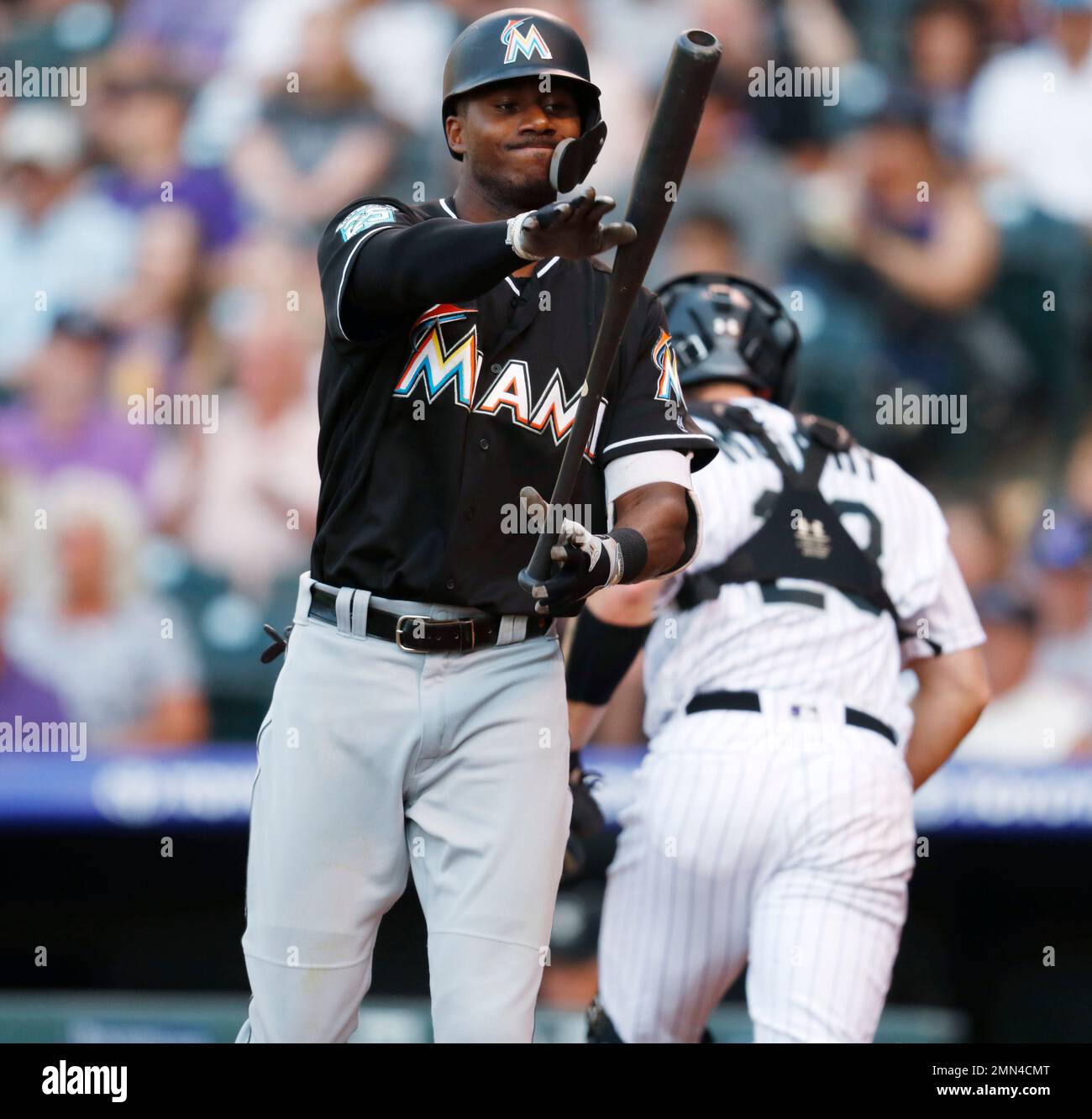 Miami Marlins' Lewis Brinson (9) strikes out with runners on base