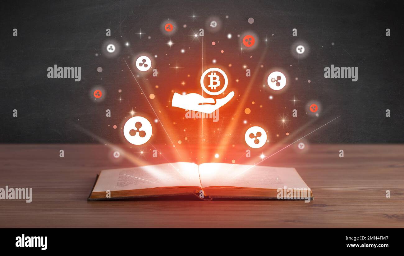 Open book with currency icons above Stock Photo - Alamy