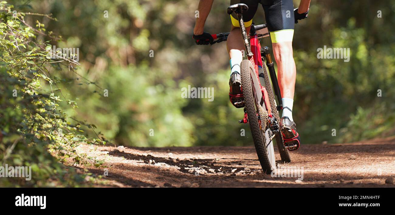 Mountain biker riding on bike singletrack trail, mountain bike race