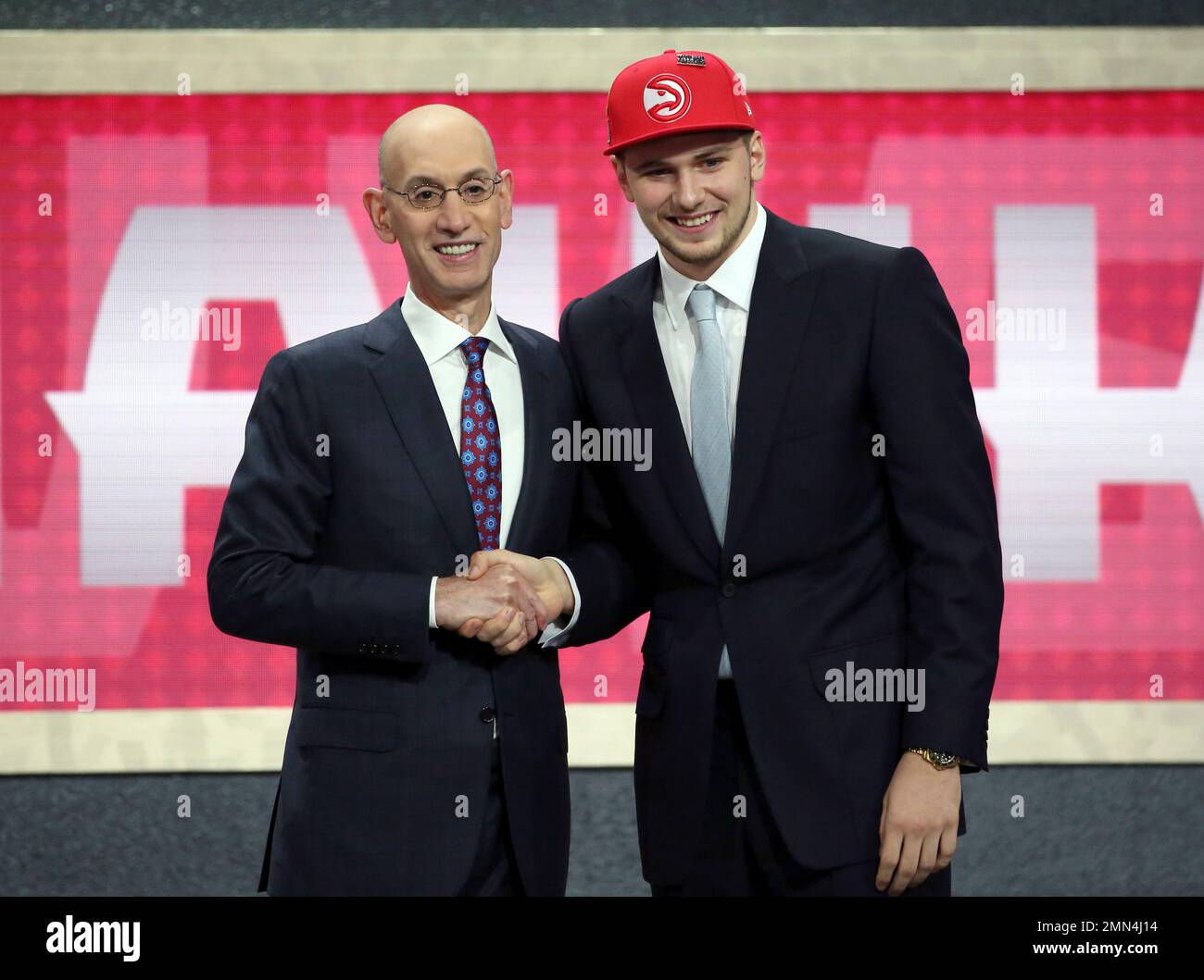 Luka Doncic who plays for Real Madrid poses for a picture with NBA Commissioner Adam Silver after Doncic was picked third overall by the Atlanta Hawks during the NBA basketball draft in