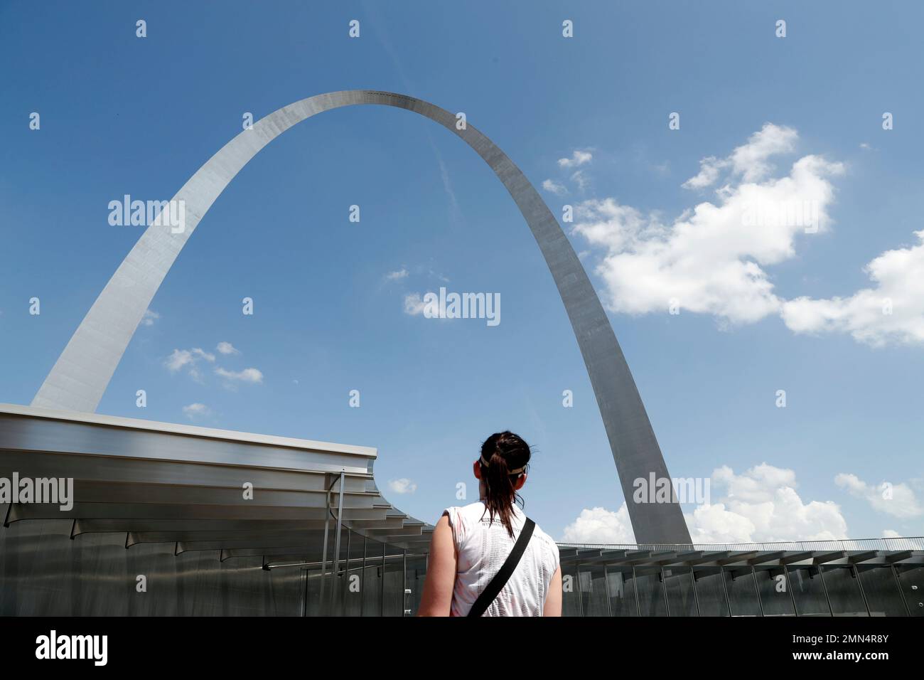 A visitor uses a new entrance to the Gateway Arch as the Old Courthouse ...