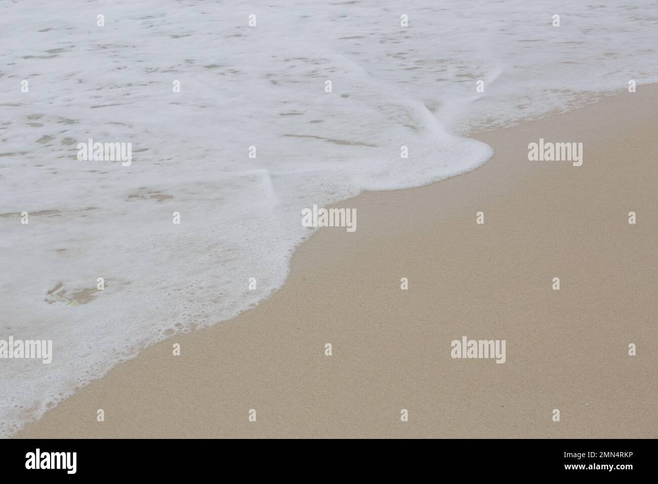 Foamy waves over sand on the tropical beach Stock Photo Alamy