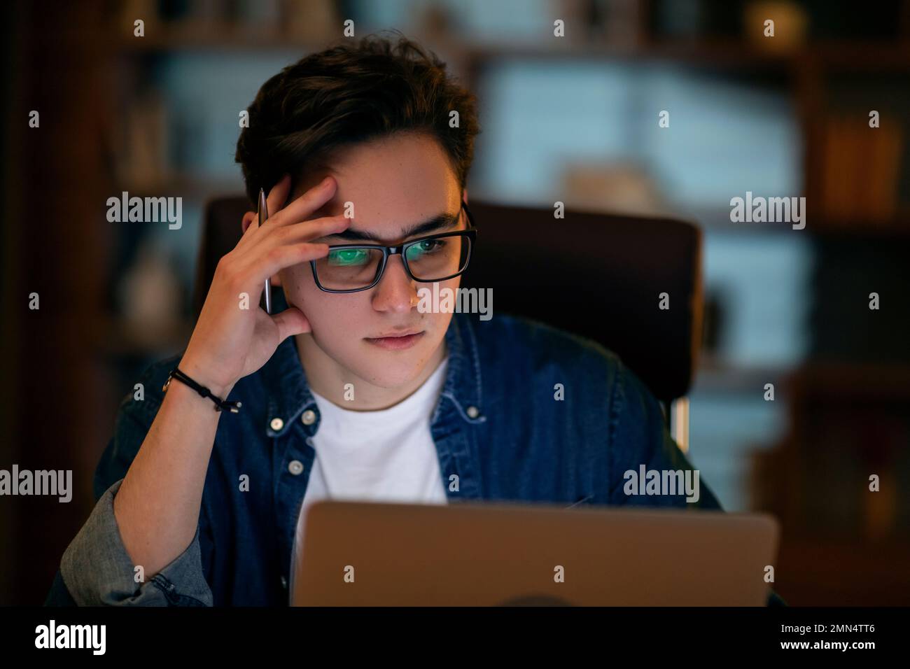 Young businessman working overtime alone in an office Stock Photo
