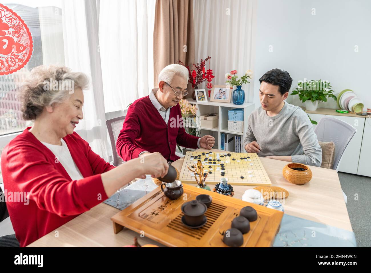 Happy family go over a cup of tea Stock Photo - Alamy