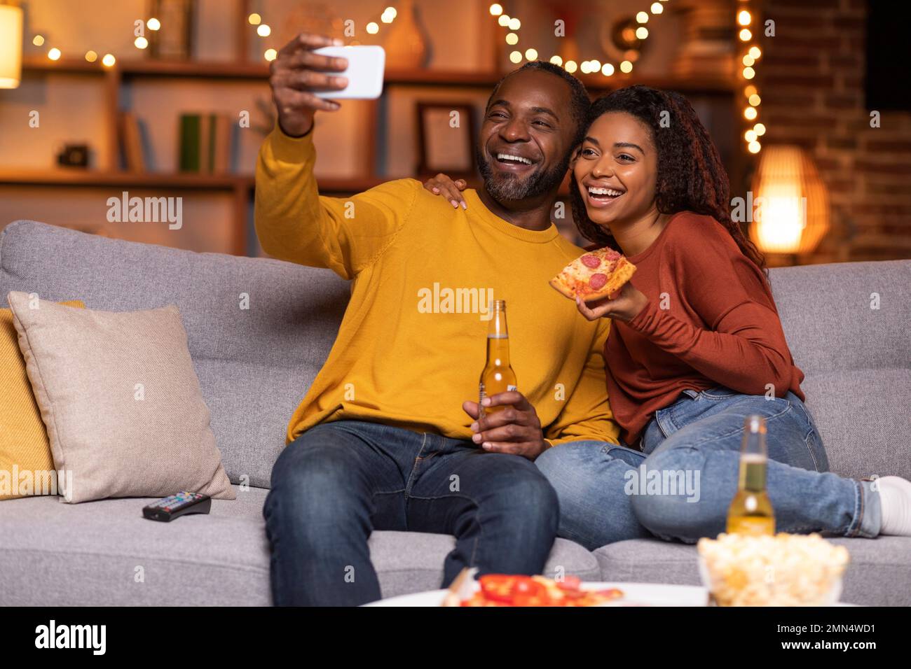 Happy black lovers taking selfie while having fun at home Stock Photo