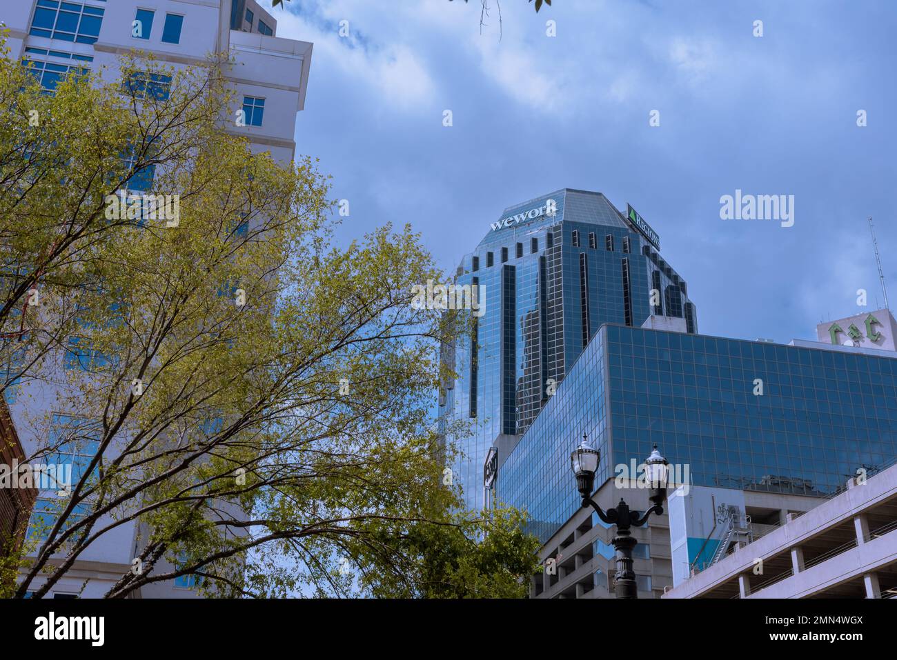 Looking up at tall glass skyscraper with office space for WeWork and Regions Bank, Nashville, Tennessee, United States. Stock Photo