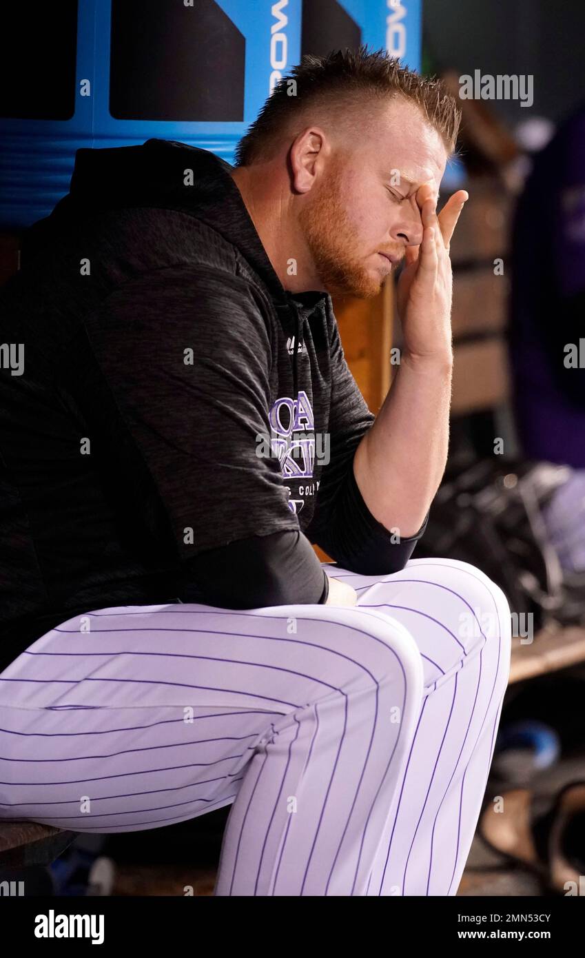 Colorado Rockies relief pitcher Brooks Pounders hangs his head in the ...