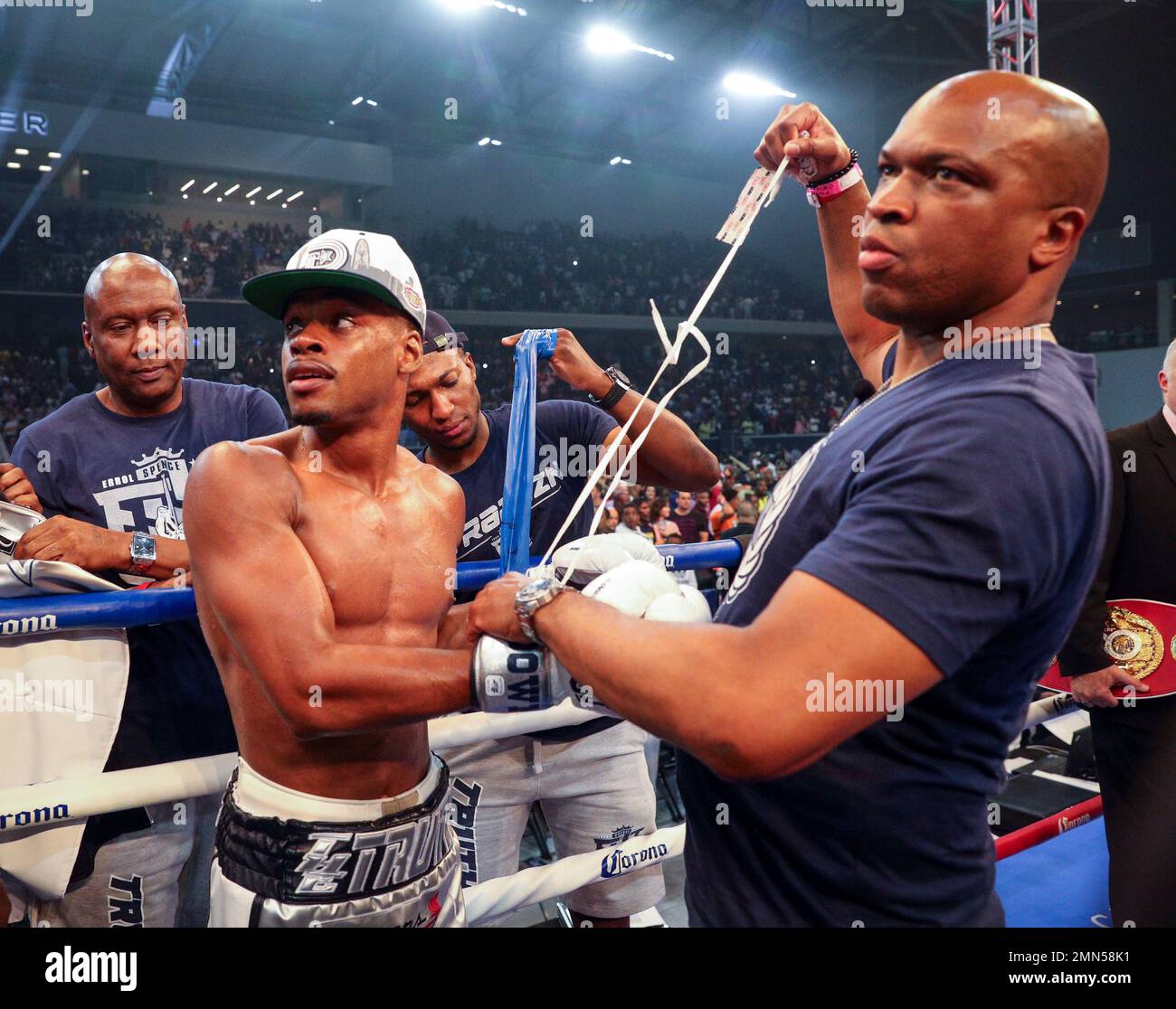 L-r) Errol Spence Jr and trainer Derrick James watch a replay of the fight after Specne knocked out Carlos Ocampo in the first round of an IBF welterweight title fight Saturday, June