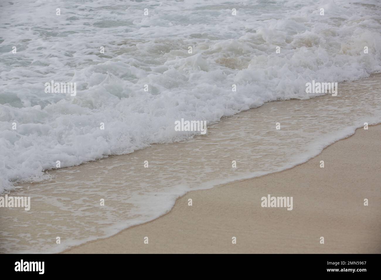 Foamy waves over sand on the tropical beach Stock Photo Alamy