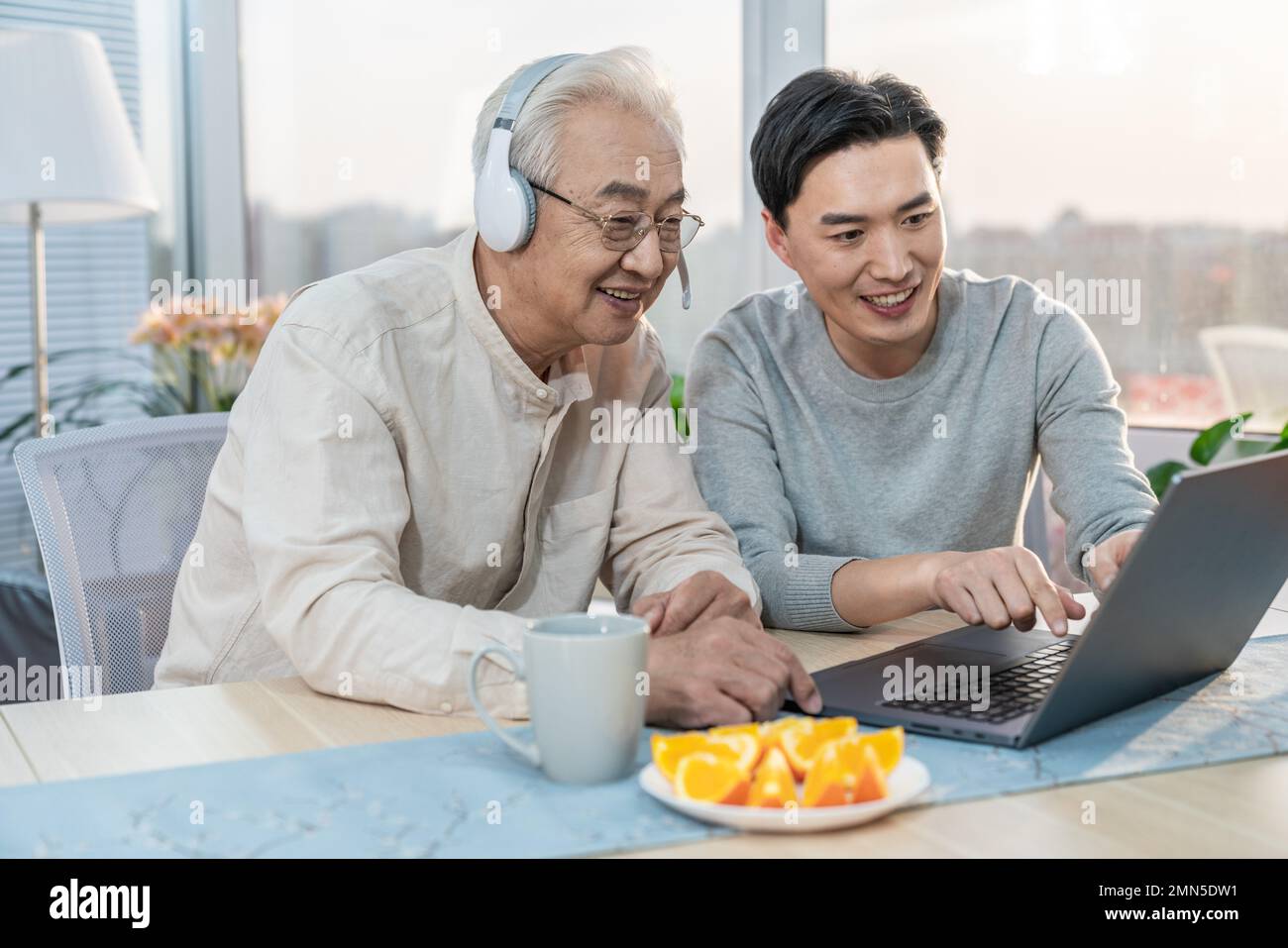 Happy father and son use notebook computer Stock Photo - Alamy