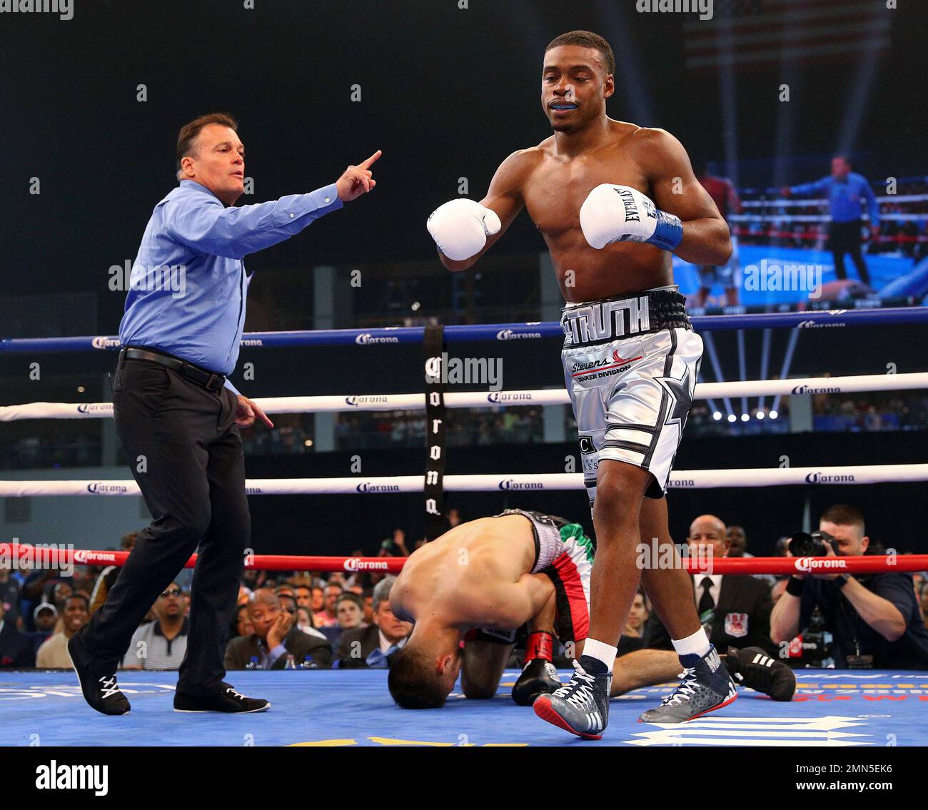 Referee Laurence Cole sends Errol Spence Jr. to a neutral corner after