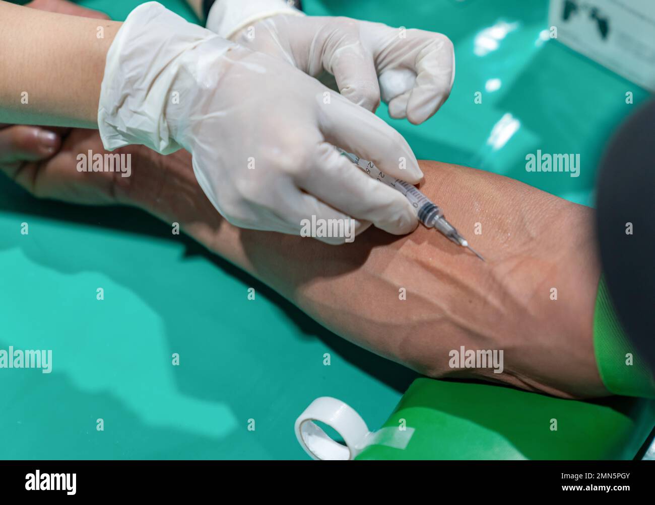 Close up needle draw blood on arm's patient for examination in annual health check Stock Photo