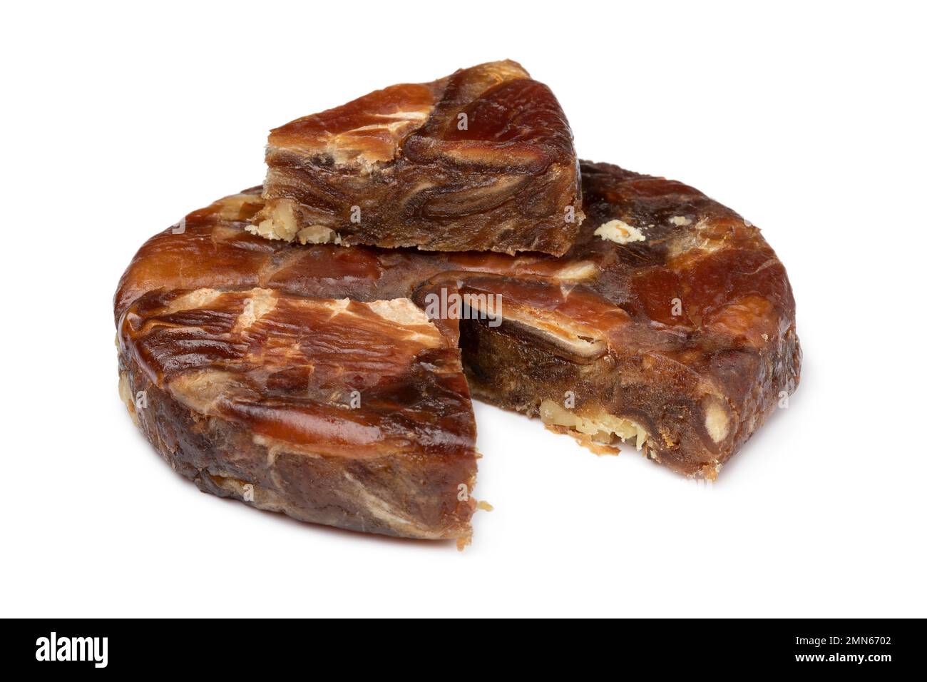 Round date bread with walnuts and a piece isolated on white background Stock Photo