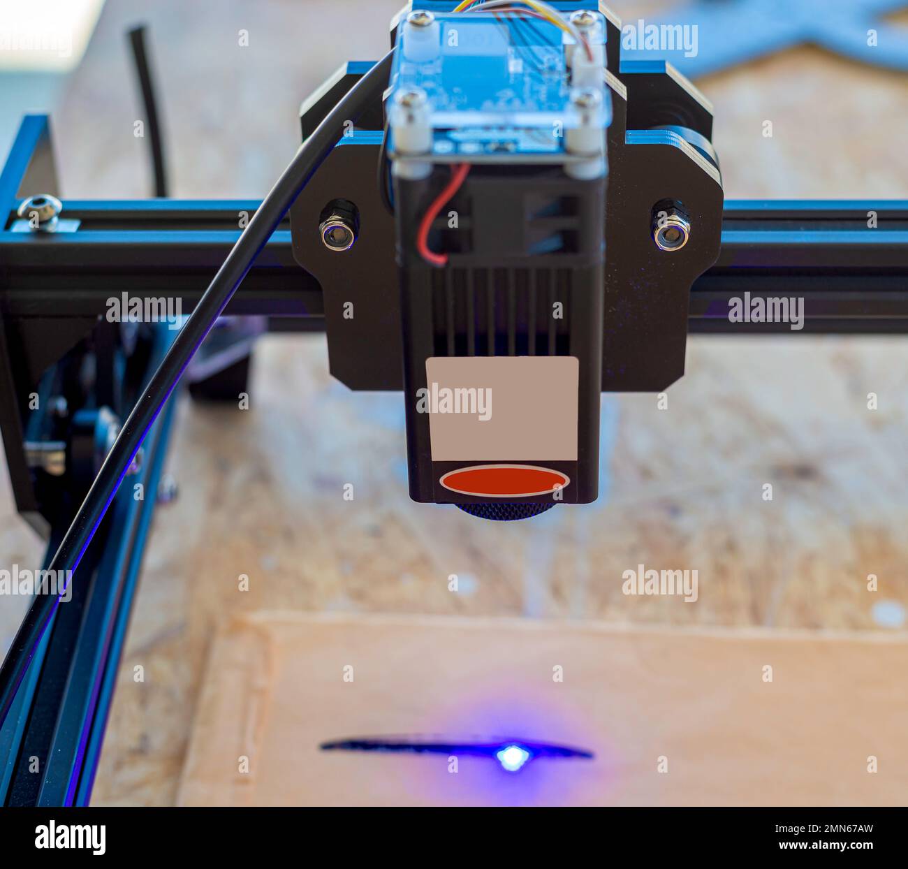 Laser engraver, laser burning on wood Stock Photo Alamy