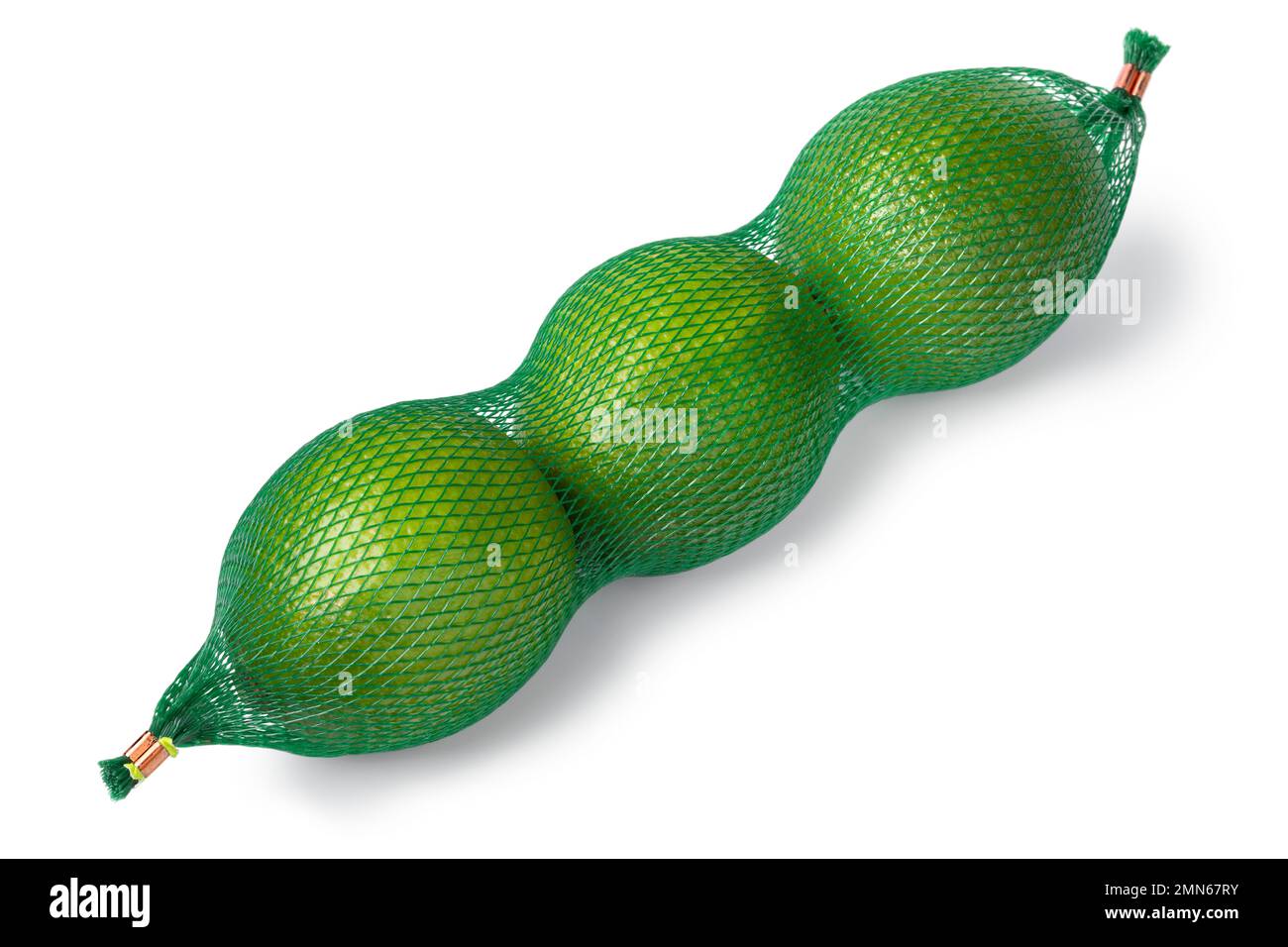 Three fresh green limes in a green bag close up isolated on white background Stock Photo