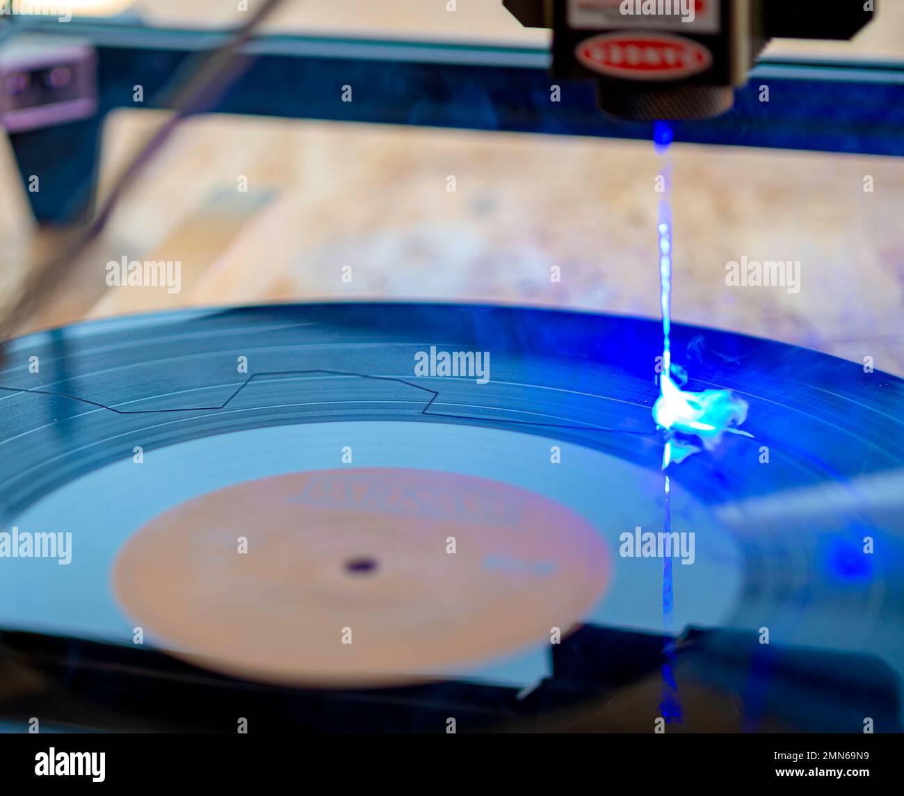 Laser engraver, laser burning on old vinyl record 33 rpm Stock Photo