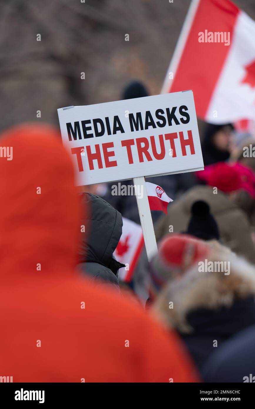 People gather at a covid-19 anti-Mask and vaccine protest. Crowds of people rallying in the streets of Toronto, Ontario Canada at Queen's Park. Stock Photo