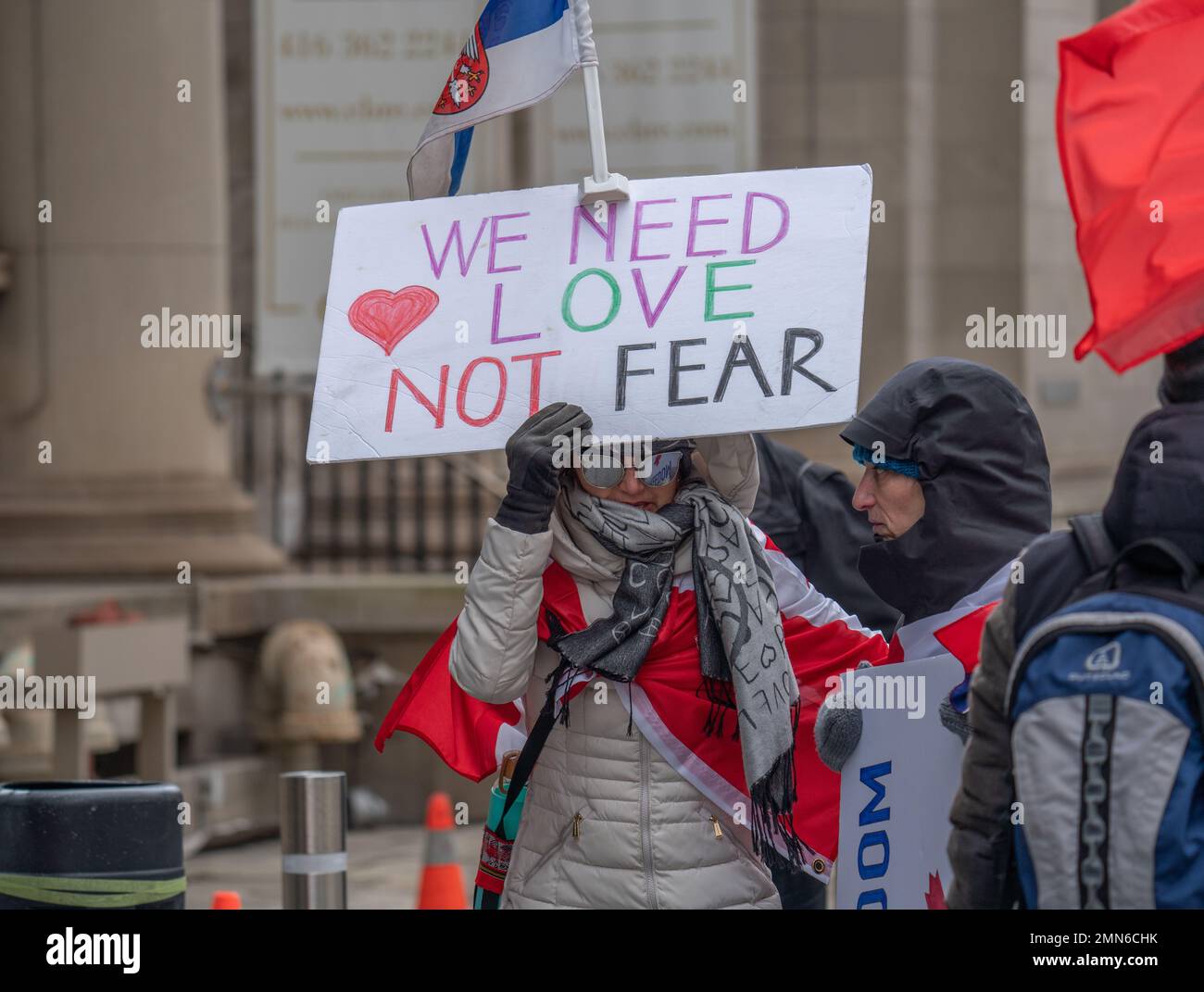 People gather at a covid-19 anti-Mask and vaccine protest. Crowds of people rallying in the streets of Toronto, Ontario Canada at Queen's Park. Stock Photo