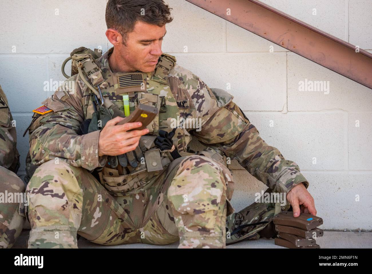 Sergeant 1st Class Jason E. Pate, 68W Combat Medics, 187th Medical Battalion,  checks his ammunition magazines while taking a break during the best medic competition M4 rifle stress qualifications, Sep. 29, 2022 at Joint Base San Antonio-Camp Bullis, Tx. The event included the Army Combat Fitness Test, obstacle course, M-4 qualification, warrior tasks and battle drills, land navigation, a Tactical Combat Casualty Care assessment and 12-Mile Ruck March. Stock Photo