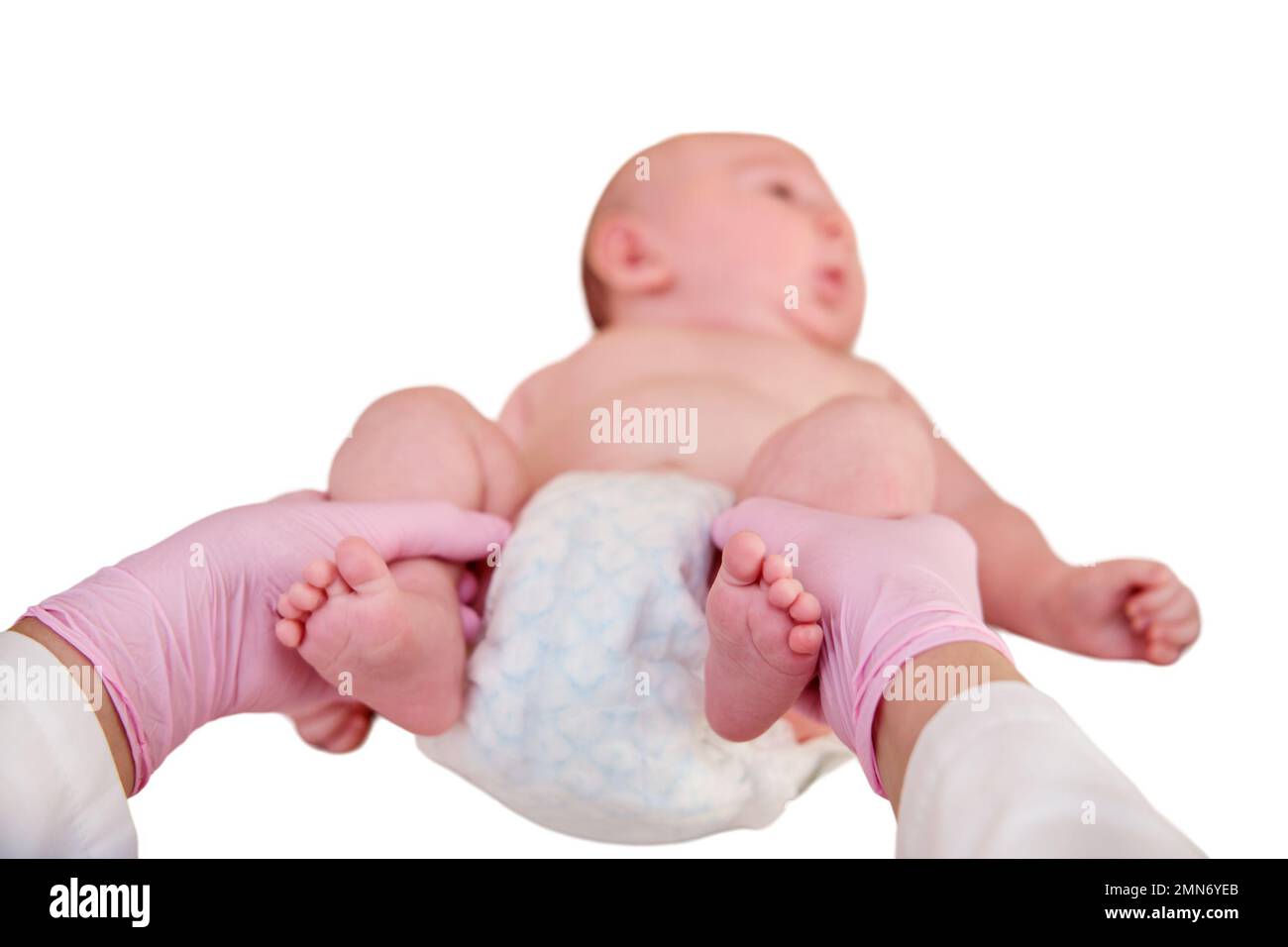The doctor does gymnastics and massage to a newborn baby, isolated on a white background. Nurse