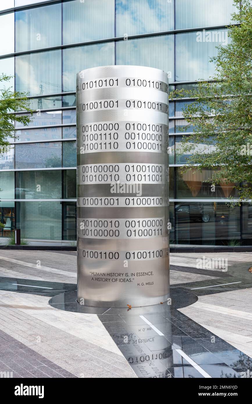 Outdoor art at the J.W. Marriott, a bright metal sculpture, the numbers 0 and 1, binary code, and a quote by HG Wells engraved into its tubular shape. Stock Photo