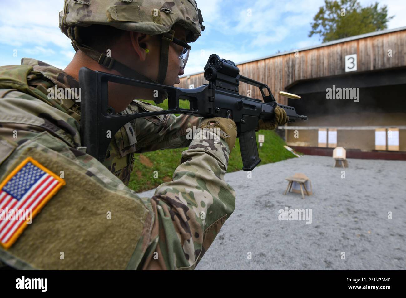 A U.S. Soldier assigned to 1st Squadron, 2nd Cavalry Regiment (1/2CR) fires a German G36 rifle during a Schuetzenschnur (German weapons proficiency test) event with the German partner unit of 1/2CR, the Panzergrenadierbataillon 112, at Regen, Germany, Sept. 29, 2022. 1/2CR provided an opportunity for exemplary Soldiers to earn a foreign award and to build camaraderie with German Army counterparts in order to strengthen NATO and multinational partnerships. Stock Photo