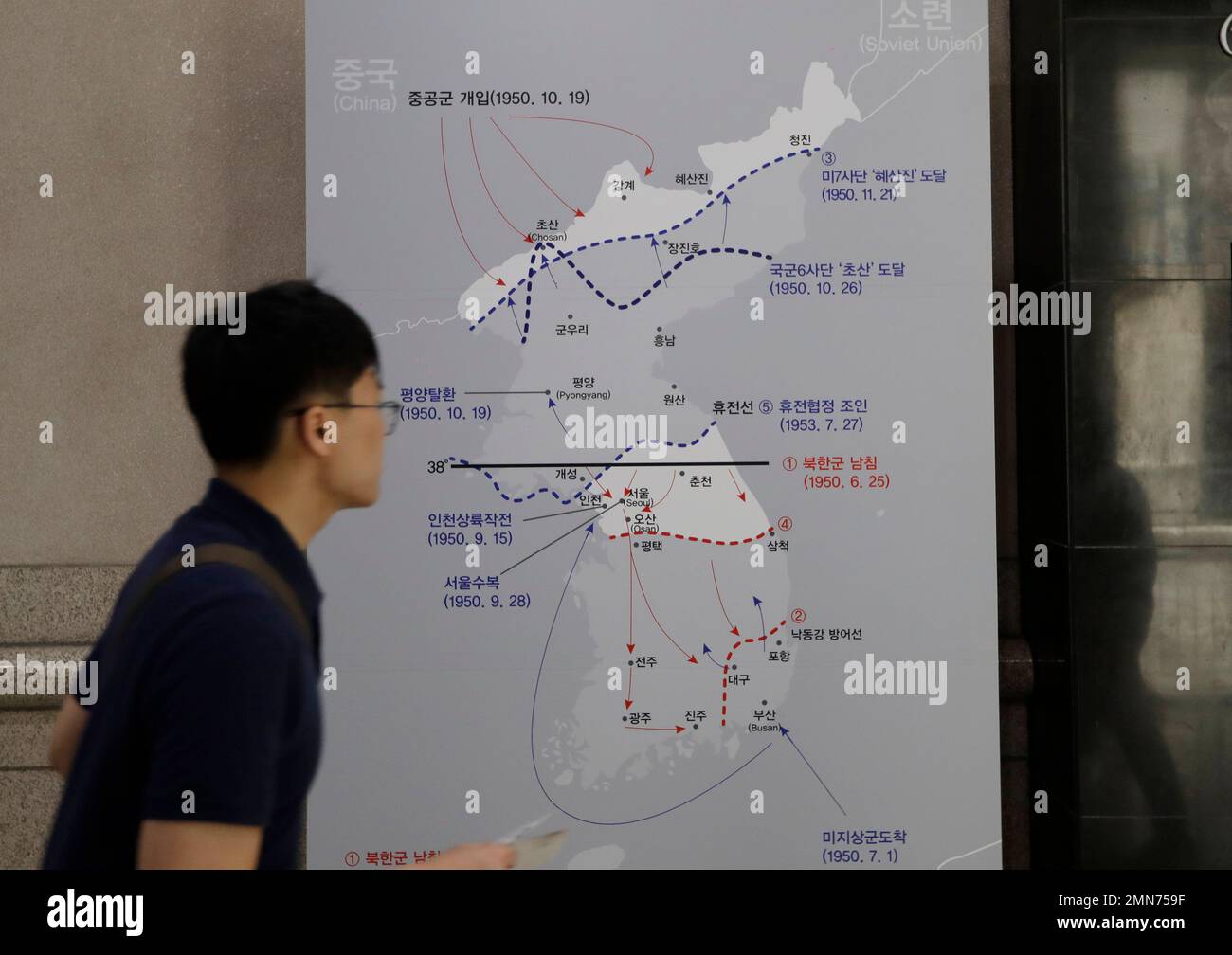 In this June 8, 2018 photo, a man walks by a map of the Korean war at ...