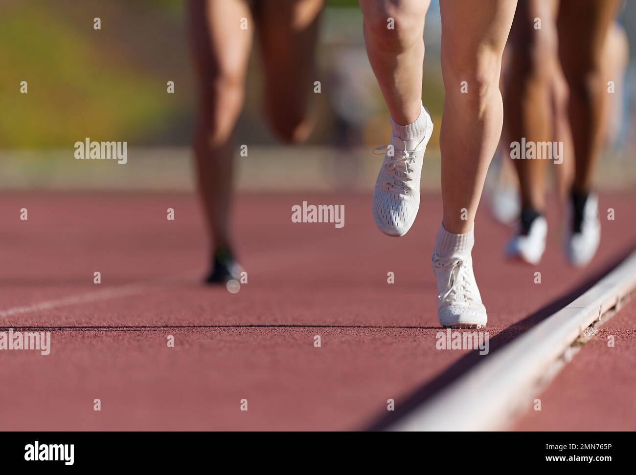 Group of athletes sprinters run speed on track of stadium Stock Photo