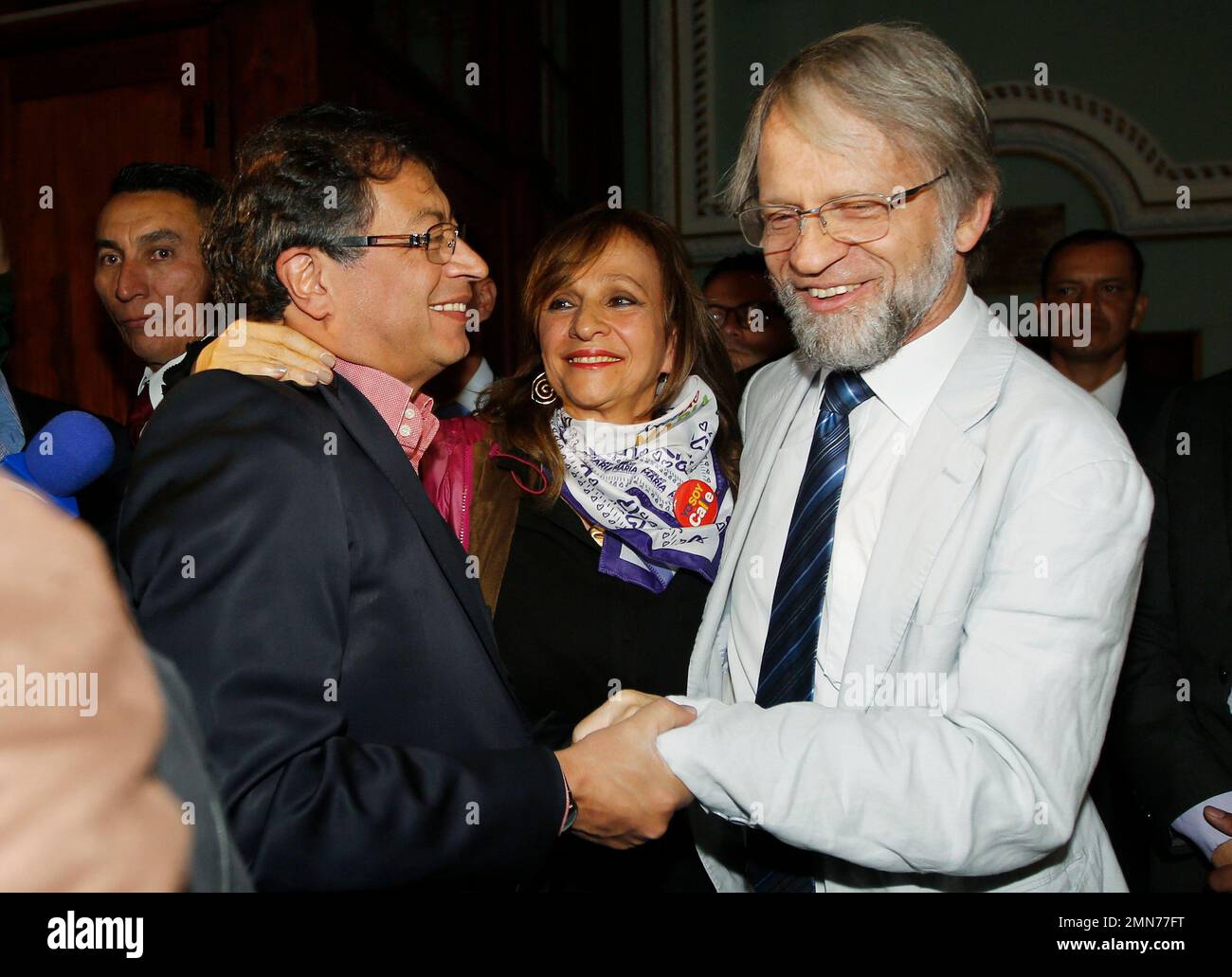 Standing next to his running mate Angela Robledo, Colombia Humana presidential candidate Gustavo Petro shakes hands with former Bogota Mayor Antanas Mockus, right, during a campaign rally in Bogota, Colombia, Friday, June 8, 2018. Petro will face Ivan Duque, presidential candidate for the Democratic Center, in a run-off election on June 17. (AP Photo/Fernando Vergara) Stock Photo