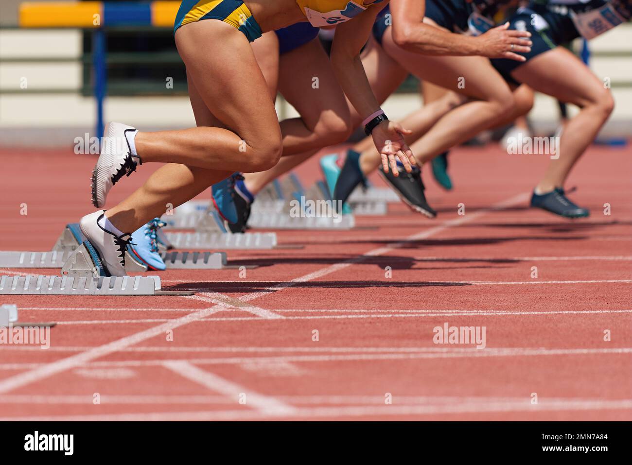 Group of female track athletes on starting blocks Stock Photo Alamy