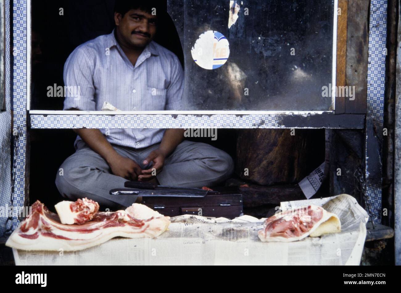 Historic Archive Image Of A Male, Man, Butcher, Selling Meat Displayed