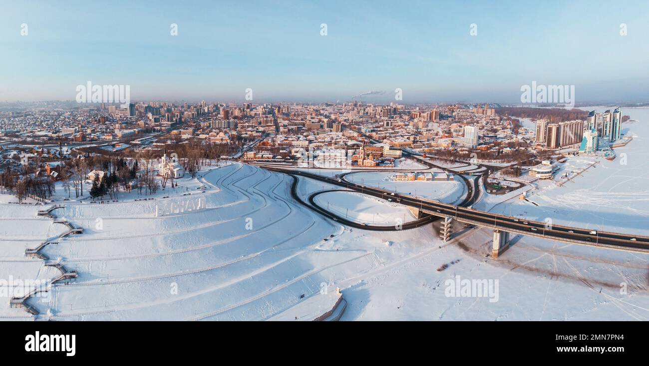 Aerial shot of bridge and car driving on the bridge, winter sunny day in Barnaul, Siberia, Russia Stock Photo