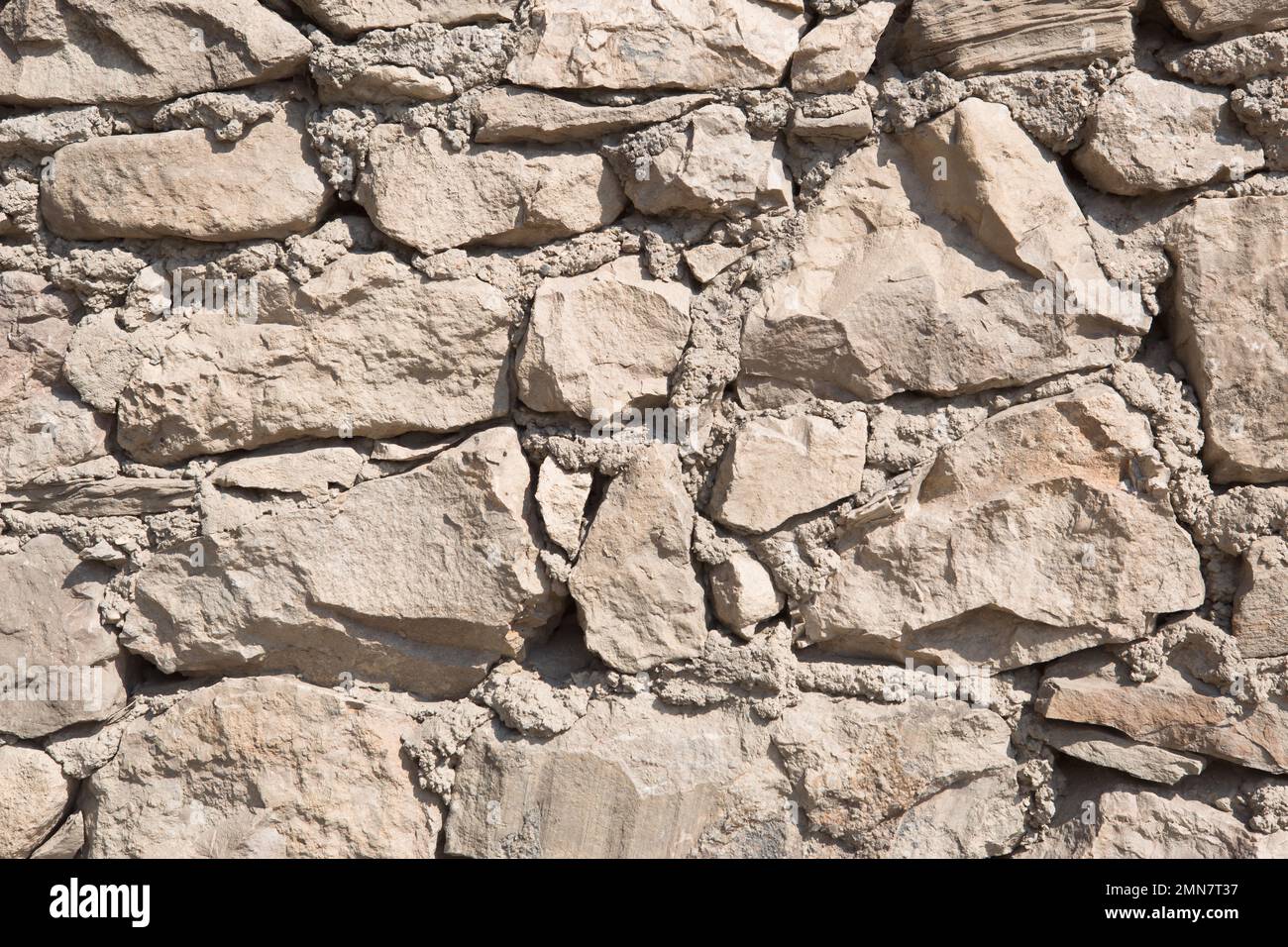 Masonry walls of natural sand color. Stone texture closeup