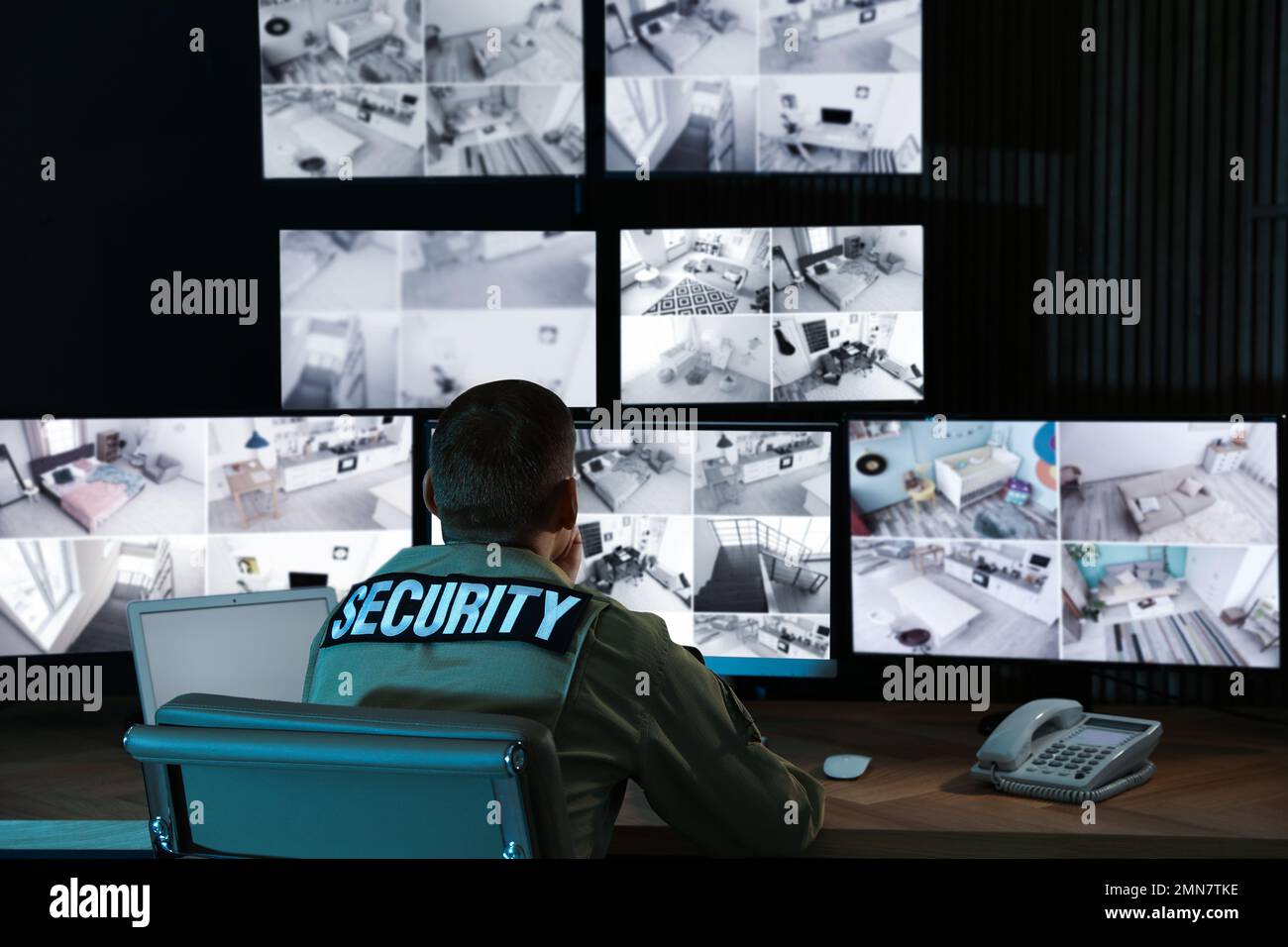 Security guard monitoring modern CCTV cameras in office Stock Photo Alamy
