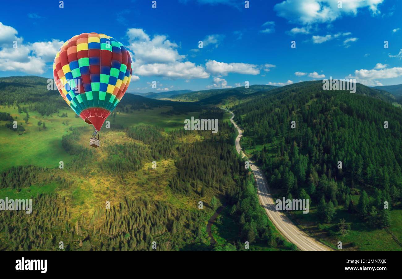 Hot air balloons floating up to the sky . Aerial drone shot Stock Photo