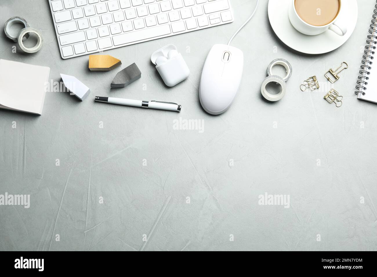 Flat lay composition with wired computer mouse and stationery on light grey table. Space for text Stock Photo