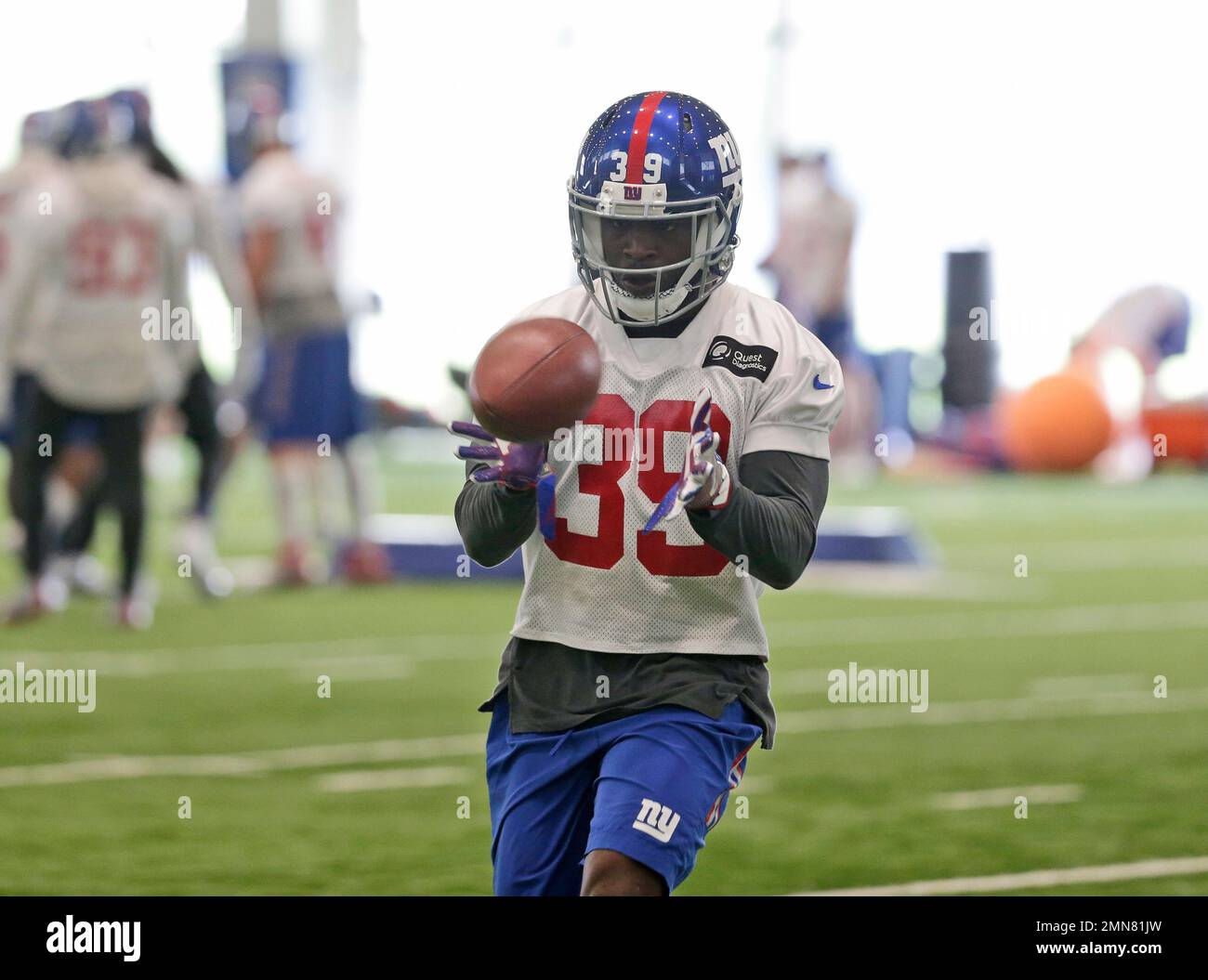 New York Giants' Madison Hedgecock (39) gets stuffed by Carolina Panthers'  Damione Lewis (92), Darwin Walker (93), Jon Beason (52) and Chris Gamble  (20) during the second quarter on Sunday, December 21