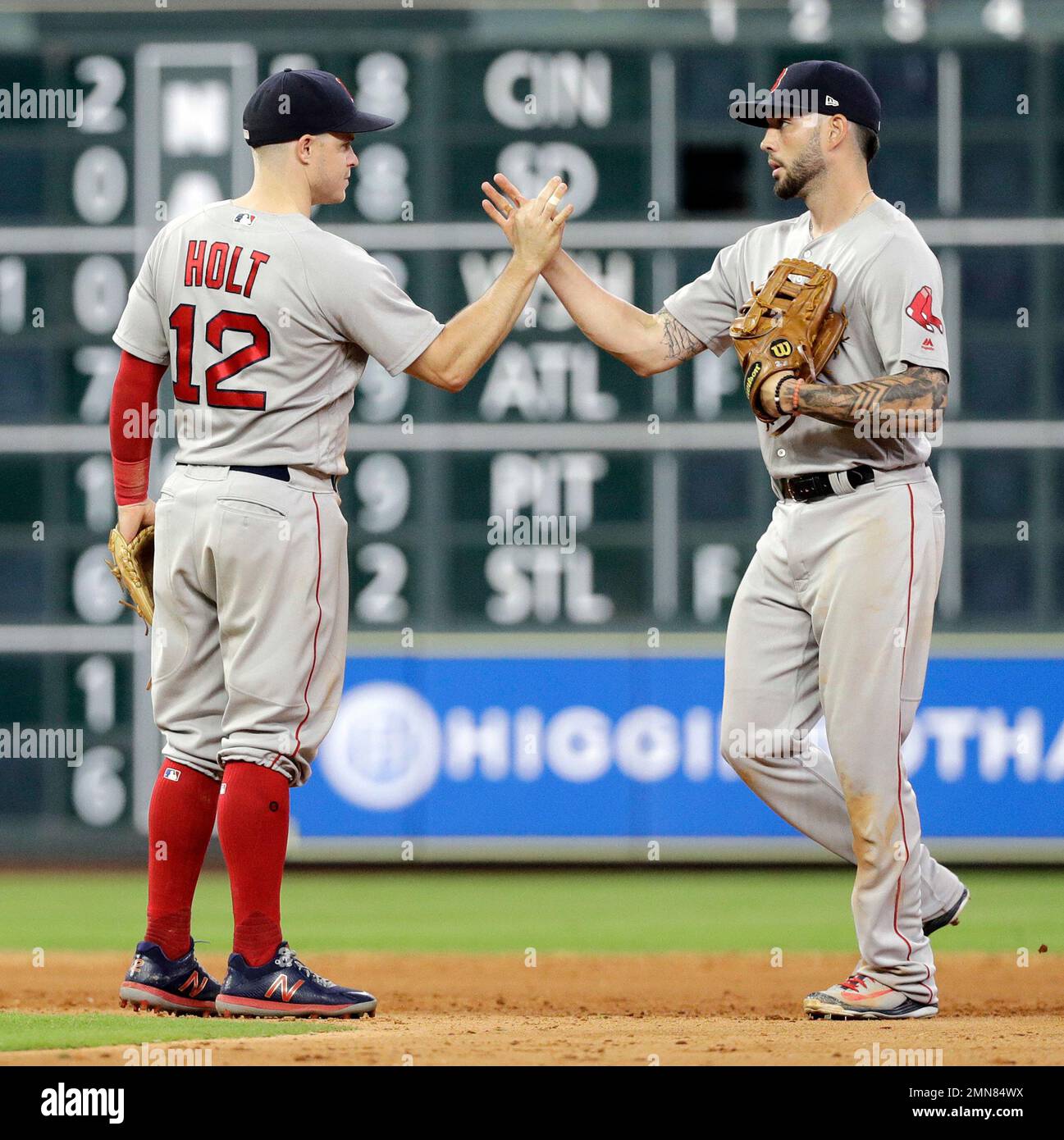 Boston Red Sox's Brock Holt (12) and Blake Swihart celebrate after