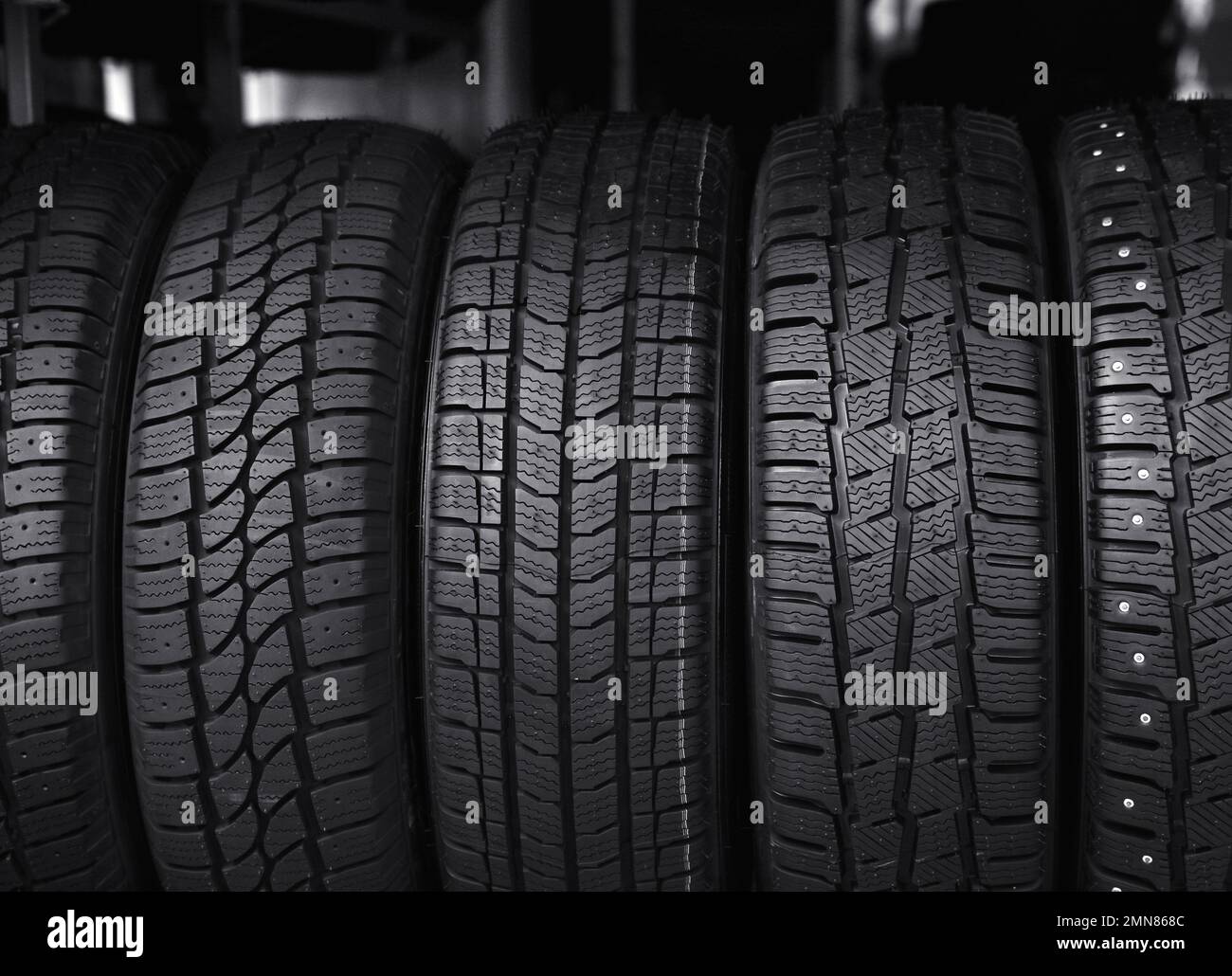 Black car tires in service store, closeup Stock Photo Alamy
