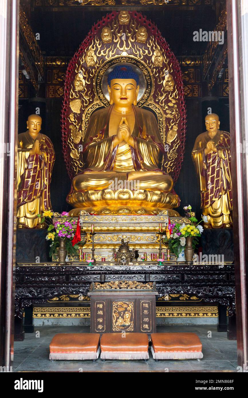 Buddhist shrine with golden Buddha on throne seat in the Hall of Sakyamuni inside the famous Daci'en Temple in the Yanta district of Xi'an. China. PRC. (125) Stock Photo